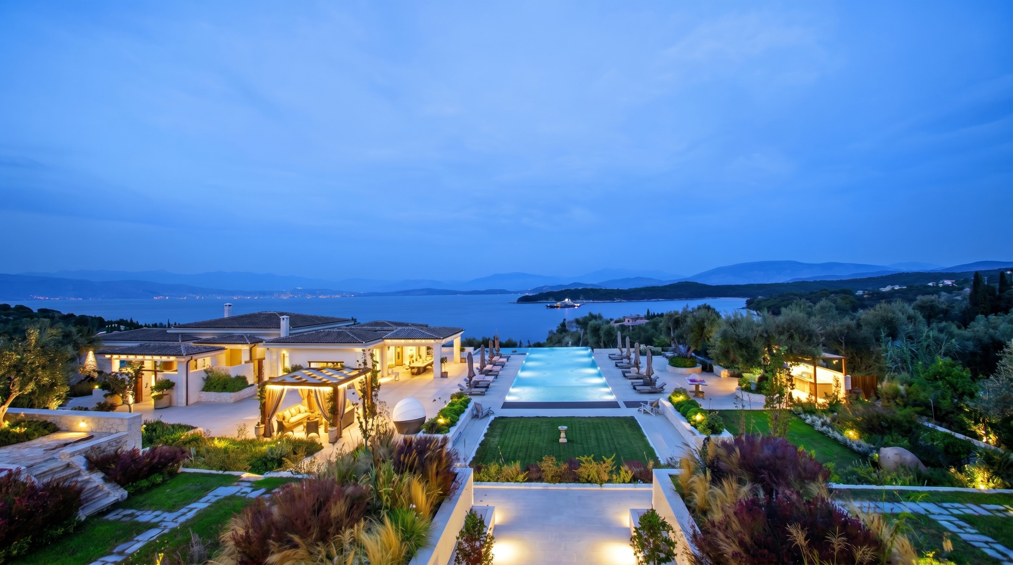Villa No. 1, A hillside estate above the bay, its stonework running from the villa walls to the water.
